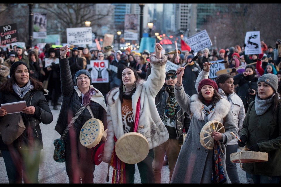 People gather outside of Queen&rsquo;s Park in Toronto on Monday during a Family Day march in support of the Wet'suwet'en hereditary chiefs.