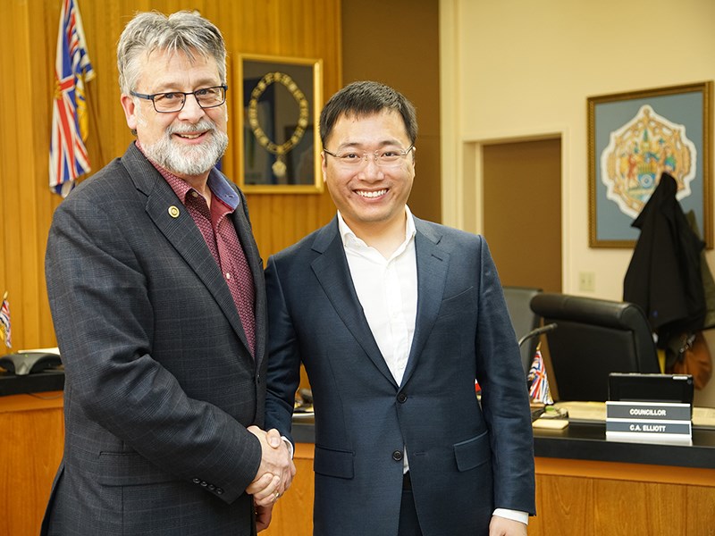 NEW HEIGHTS: City of Powell River mayor Dave Formosa [left] greets Victor Gao, director and vice-president of Gaoshi Holdings (Canada) Ltd., which is proposing a four-phased development at Powell River Airport. Paul Galinski photo