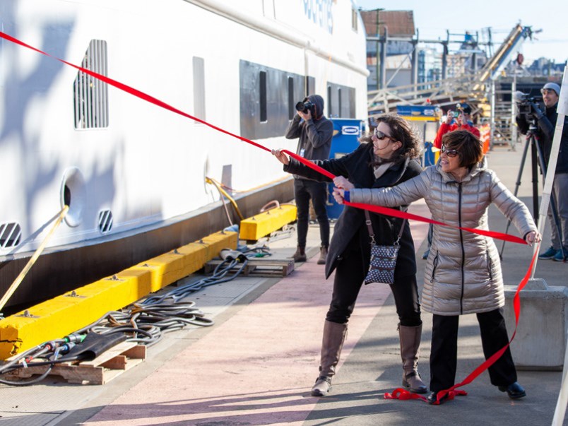 Island Discovery sponsors Sandy Leduc and Sandy McCormick pull a ribbon that smashes a bottle of champagne against the hull of the new ship at a christening ceremony in Victoria on Wednesday, Feb. 19.