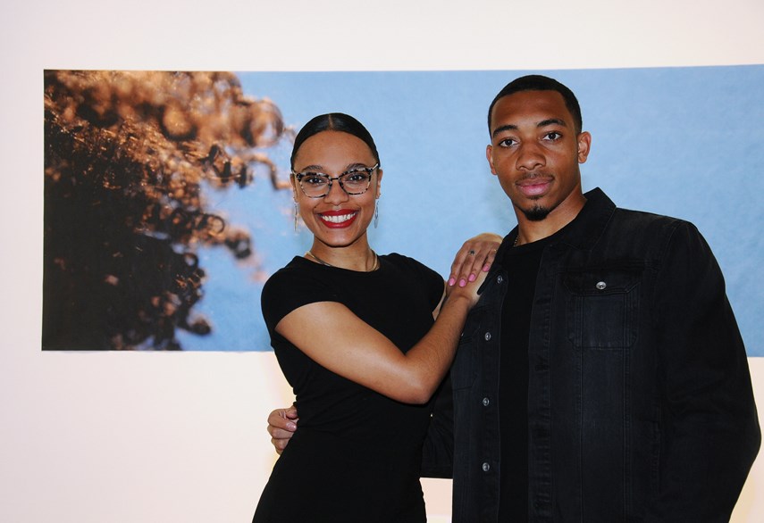 Featured artist Rebecca Bair with her brother Theo Bair in front of her work titled Reach and Coil.