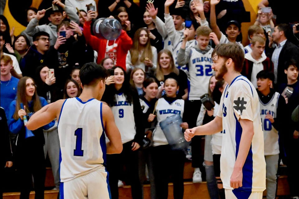 McMath's Travis Hamberger and John Laitnen celebrate in front of school supporters as the Wildcats captured the Richmond Senior Boys Championship Thursday night with a 79-64 win over the Steveston-London Sharks at a packed Hugh Boyd Secondary gym.