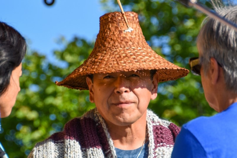 Organizers of the National Indigenous People's Day event welcome newly-elected Kwikwetlem Chief Ed Hall, who took up the role last year, by wrapping him in a blanket.