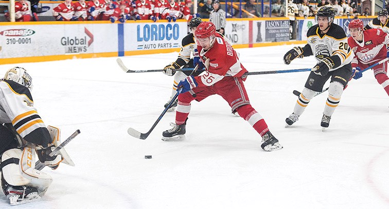 Citizen Photo by James Doyle. Prince George Spruce Kings forward Preston Brodziak goes one-on-one against Coquitlam Express goaltender Jack Watson while being hooked from behind by defender Steven Bellini on Friday night at Rolling Mix Concrete Arena.