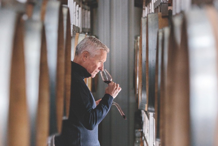 Painted Rock owner John Skinner enjoys some wine in his barrel room