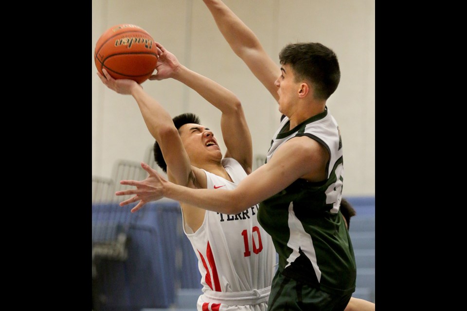 MARIO BARTEL/THE TRI-CITY NEWS
Terry Fox Ravens guard Kenny Cogoy goes up against Burnaby Mountain defender Pedro Halfen Peter dos Santos in the first quarter of their first round game at the Fraser North championships, last Thursday at Centennial secondary in Coquitlam. Fox won, 94-58.