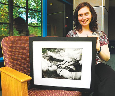 Gateway's general manager Suzanne Haines holds Christina Passey's piece titled Anticipation, a juxtaposition of the meticulous tying up of ballet shoes and a dishevelled background.