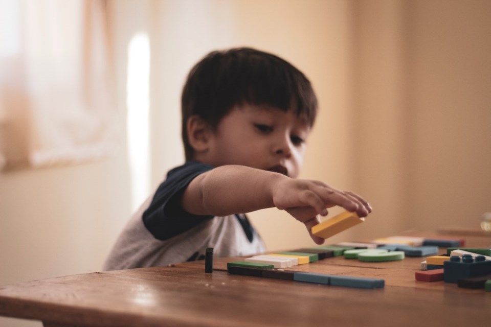 Child playing with letter blocks