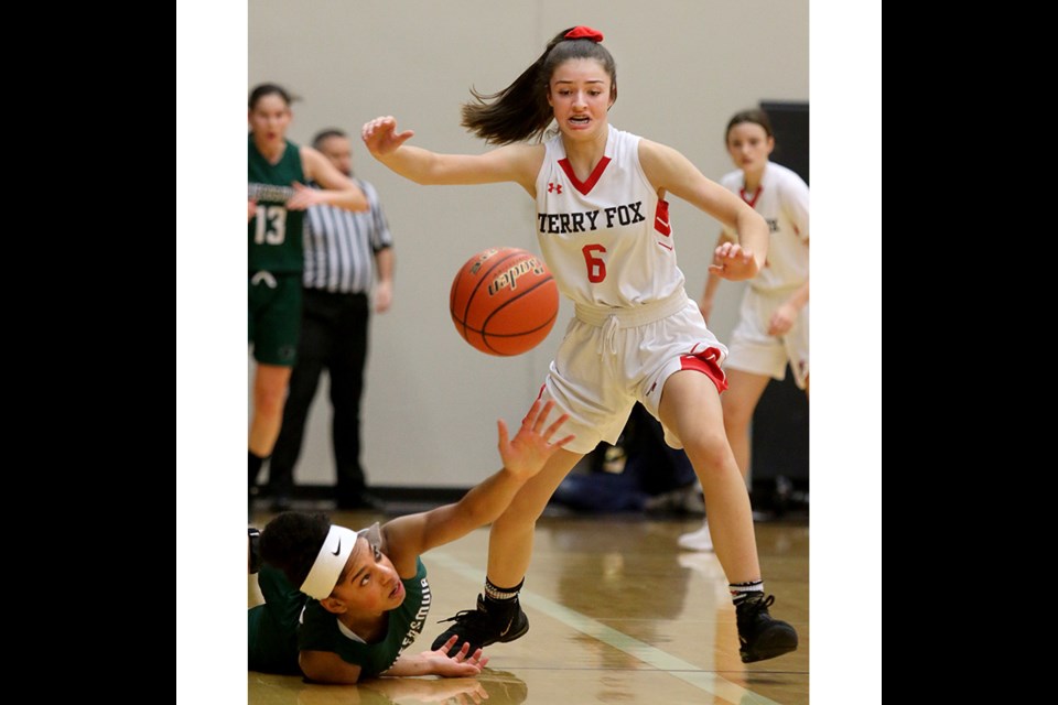 MARIO BARTEL/THE TRI-CITY NEWS
Alisha Weloy, of the Terry Fox Ravens, knocks the ball out of the reach of Lord Tweedsmuir's India Aikins, in the first quarter of their quarter-final game at the BC High School AAAA girls basketball championships, Thursday at the Langley Events Centre. Fox won, 76-73.