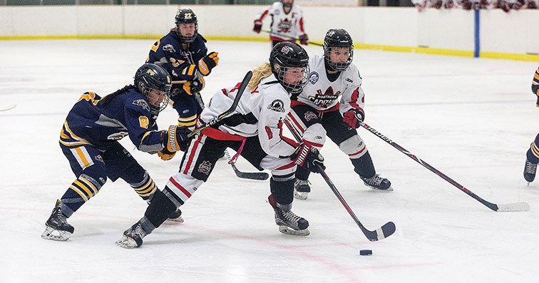 Citizen Photo by James Doyle. Northern Capitals forward Brette Kerley breaks in on net while being checked from behind by Fraser Valley Rush defender Julia Lee on Friday evening in Kin 2.