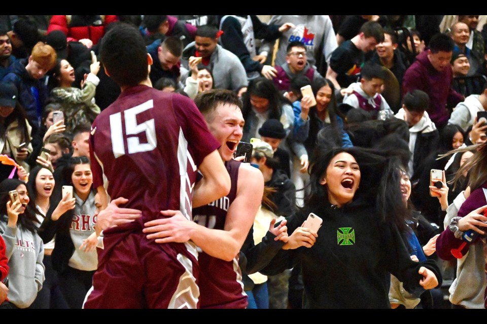 Richmond Colts' Lazar Stanojevic and Arminas Ilciukas embrace at the buzzer in their team's 70-64 win over the MacNeill Ravens Friday night to capture the inaugural South Fraser 3A Championship in front of a capacity crowd at Steveston-London Secondary.