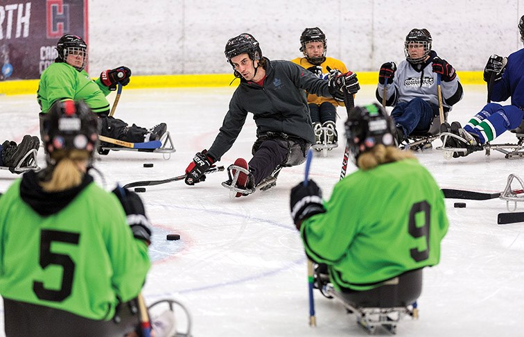 Citizen Photo by James Doyle. B.C. Hockey Para Ice Hockey Coordinator James Gemmell, centre, leads a stick handling drill on Saturday at Kin 1 during SportAbility BC’s Para Ice Hockey Development Camp.