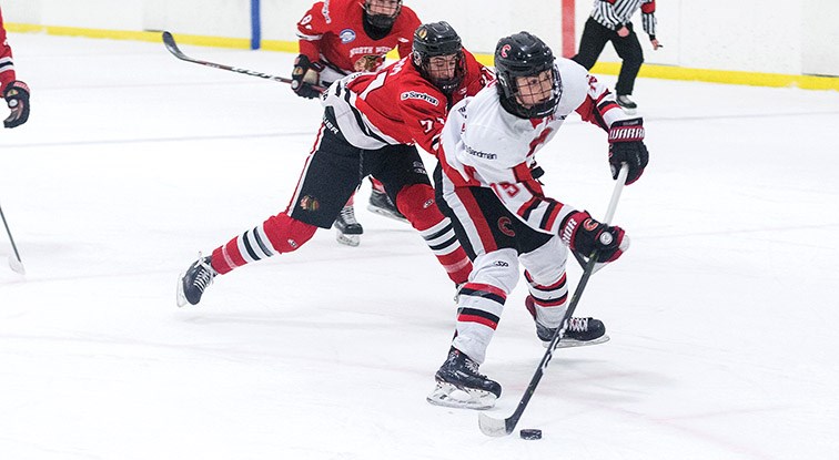 Citizen Photo by James Doyle. Cariboo Minor Midget Cougars forward Linden Makow breaks in alone while being checked from behind by Vancouver North West Hawks defender Gabriel Adam on Sunday morning in Kin 2.