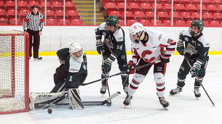 Citizen Photo by James Doyle. Cariboo Cougars forward Carter Yarish tries to put a backhand shot over the pad of North Island Silvertips goaltender Evan May on Sunday morning in Kin 1.