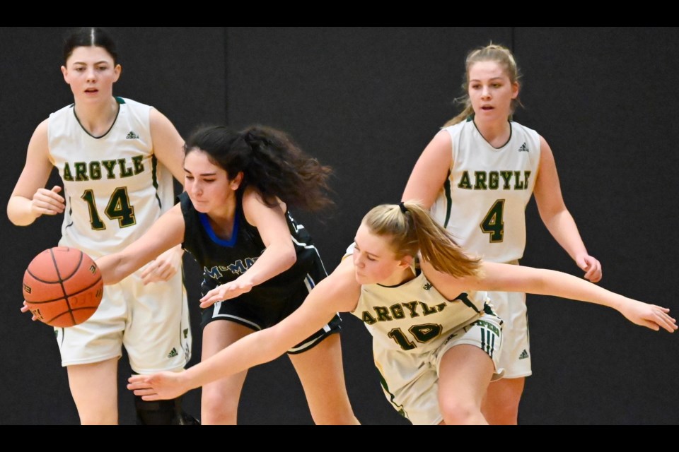 McMath's Marina Radocaj reaches for the loose ball during action in Saturday's third place game against Argyle at the BC 3A Girls Basketball Championships. The Wildcats finished fourth after falling 76-70 in overtime.
