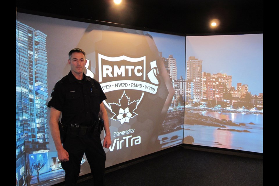 Delta police S/Sgt. Mo Parry unveils the new high-tech training simulator to assembled media Monday afternoon.
