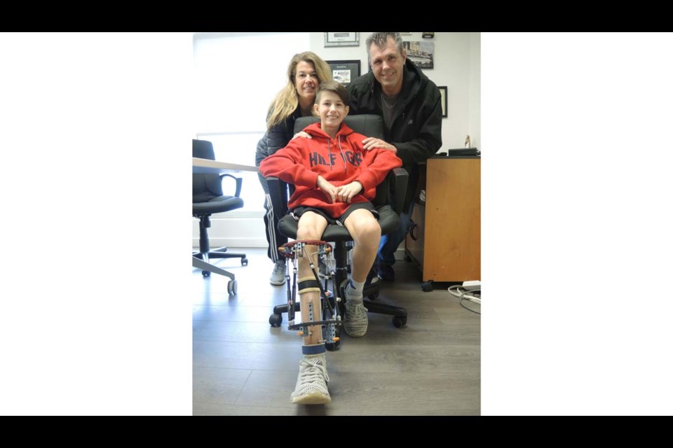 Riley McCluskey, with his parents, Nancy and Shawn. Alan Campbell photo