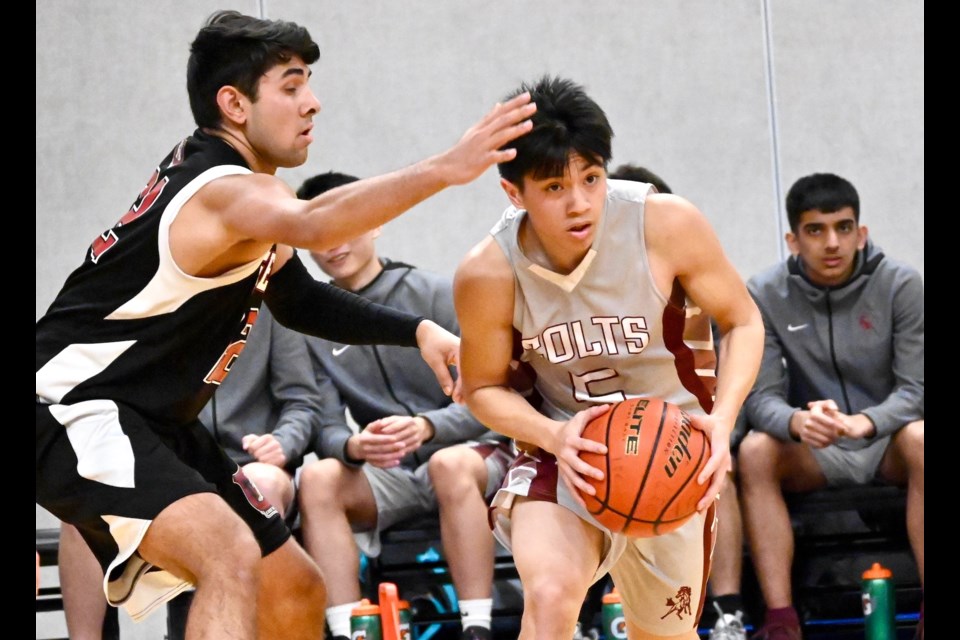 Richmond Colts' Santiago Avancena looks to get past a Magee opponent during opening round action on Wednesday at the BC 3A Basketball Championships at the Langley Events Centre. Richmond fell 73-57 to the Vancouver school.