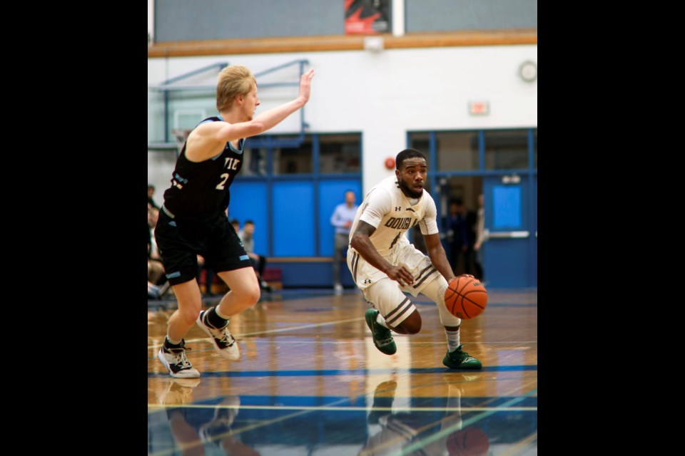 Tourney MVP Courtney Anderson, at right, drives down court to lead his Douglas College Royals past Vancouver Island in the PacWest men's basketball final.