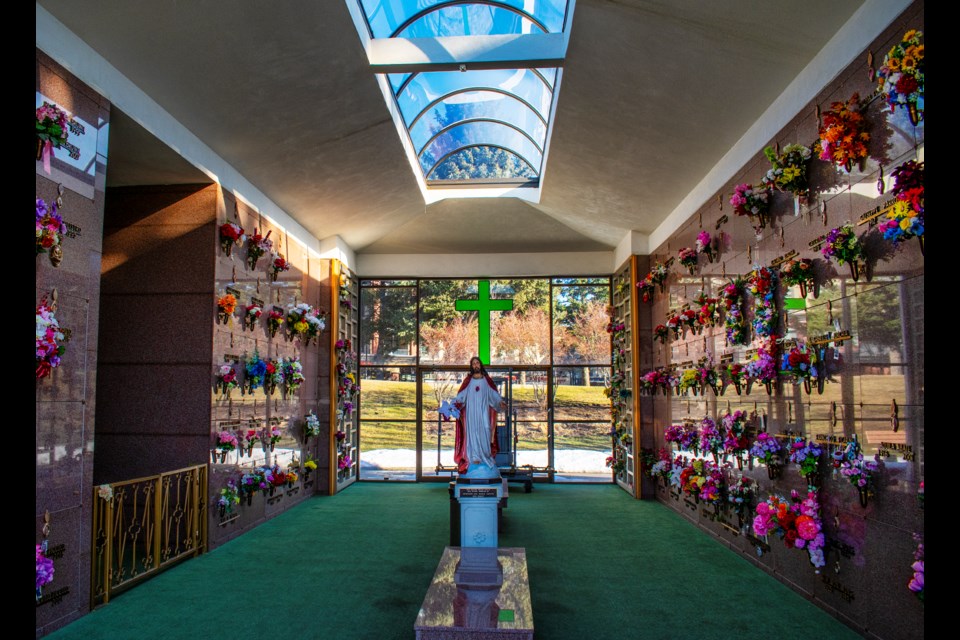 A statue of Jesus stands among the remains of loved ones in a mausoleum at the city’s Hillside Cemetery.