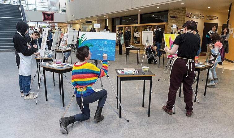 Citizen Photo by James Doyle. Students work on their paintings during the first round of competition at the Art Battle Duchess Park SD #57 Youth Tournament on Wednesday evening at Duchess Park Secondary.