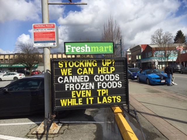 COVID-19 sign in front of a grocery store