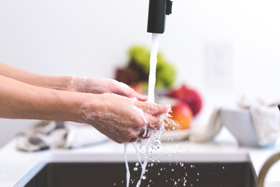 Washing hands under a tap