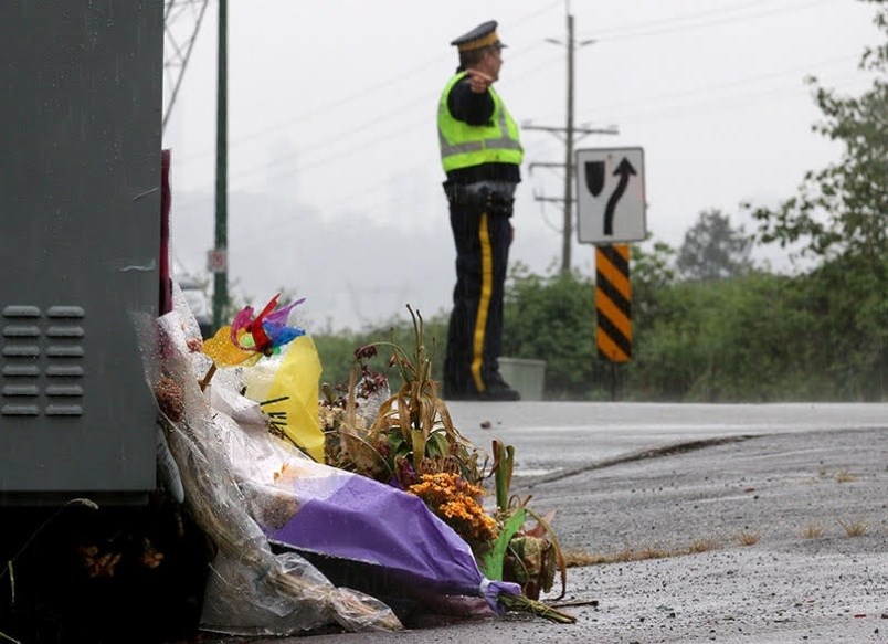 An RCMP officer takes part in the reconstruction of a car crash in late March on Mariner Way that took the life of 13-year-old Deborah Seol of Coquitlam.