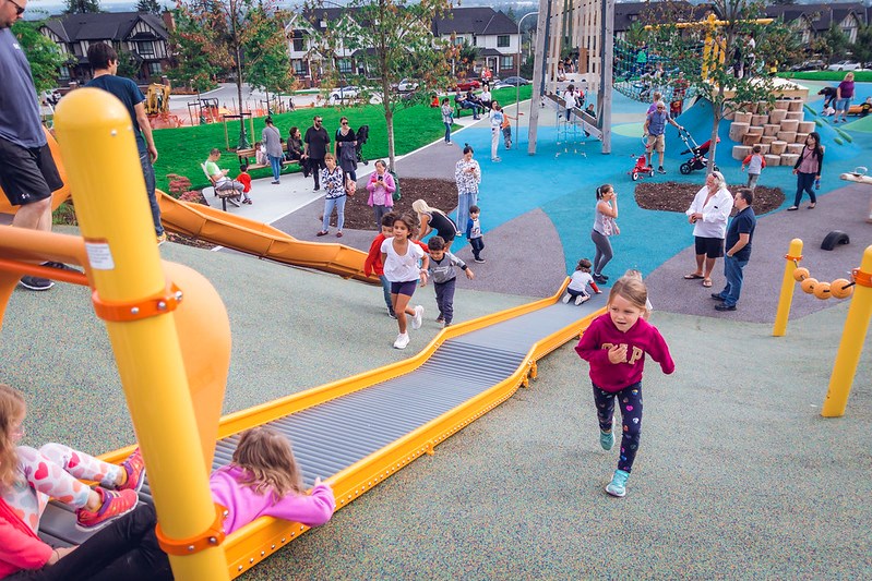 Children play at the opening of Smiling Creek Park on Burke Mountain in September 2019.