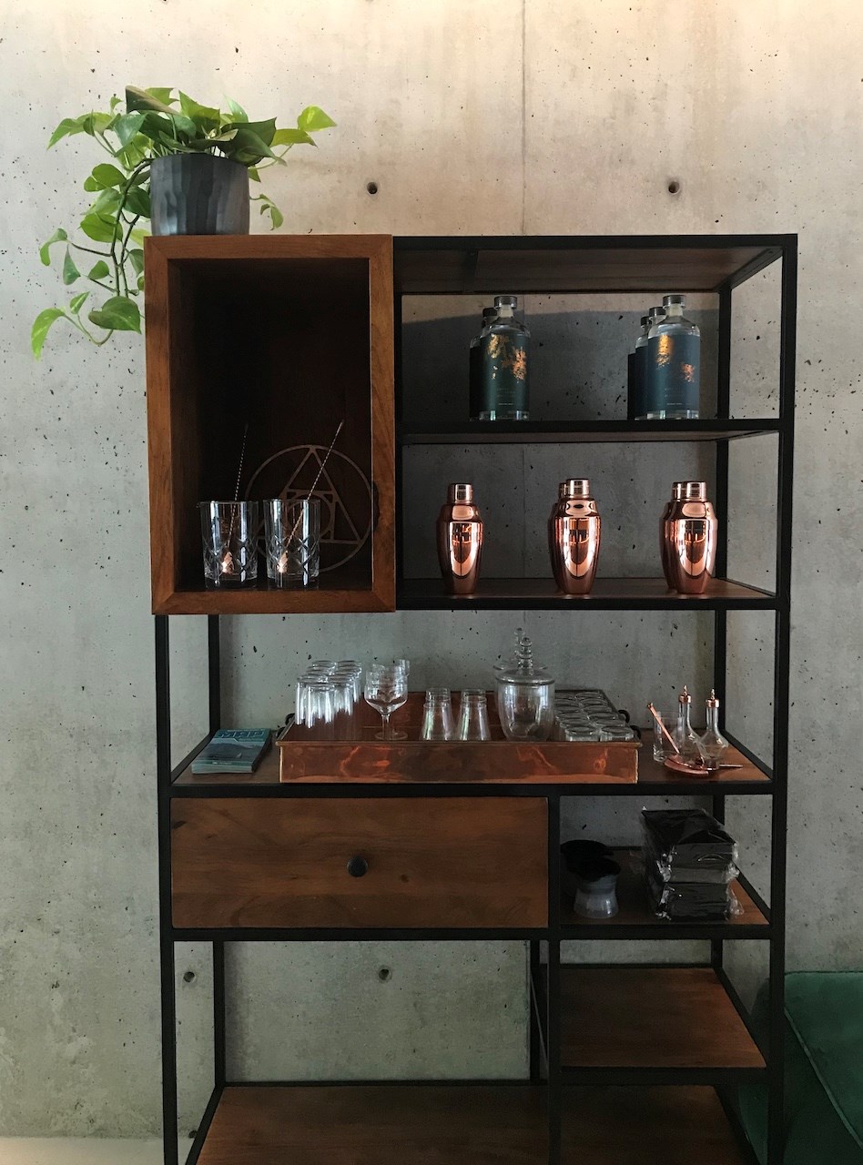 A shelf full of liquor products and accessories