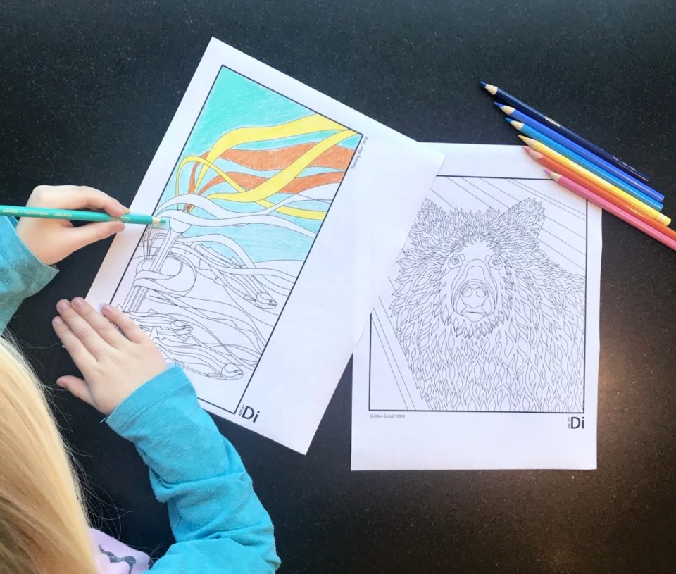Child colouring in a seaweed colouring page