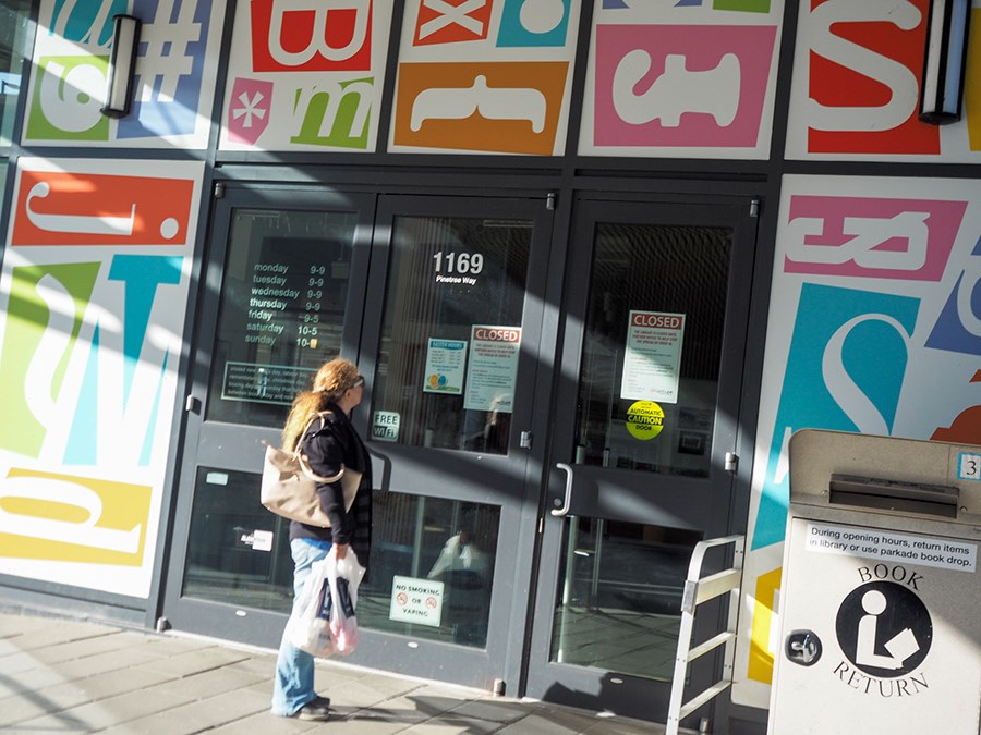 woman standing outside coquitlam library closed due to covid-19 pandemic