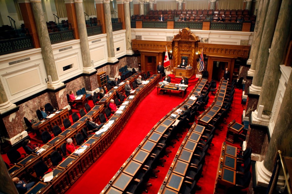 Premier John Horgan and a dozen MLAs gather in the legislative assembly to make special statements about the COVID-19 pandemic during a rare event at the Legislature in Victoria, B.C., on Monday, March 23, 2020. THE CANADIAN PRESS/Chad Hipolito