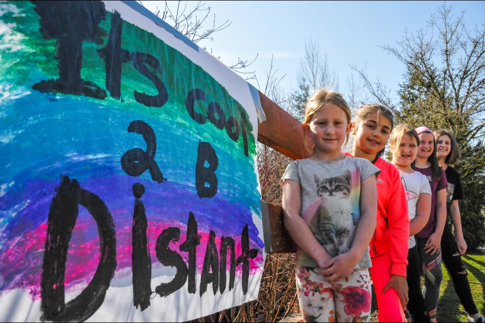 Seven children from Port Moody painted uplifting messages along their street to bring the community together from a distance.