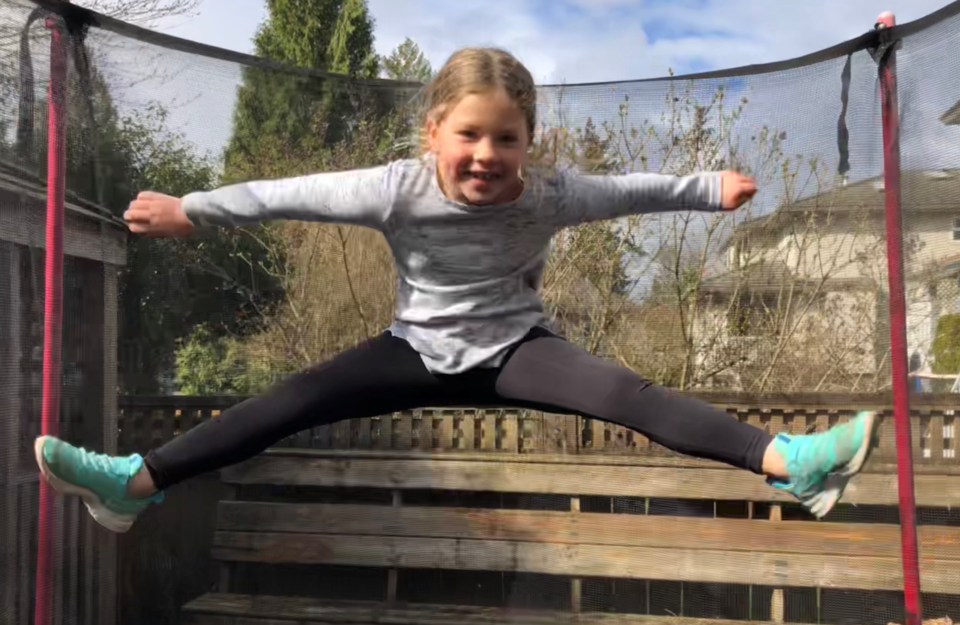 Sierra Matuschewski, 6, burns off some energy in her Burke Mountain backyard. Her mother, Kyla McLeo