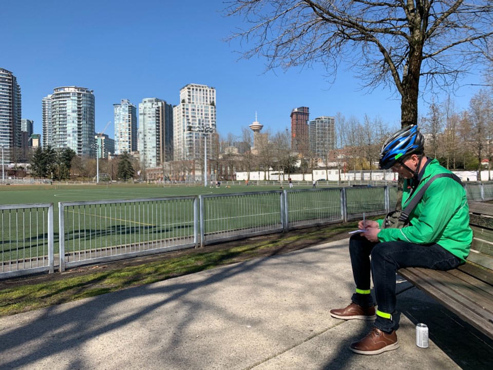 Reporter Mike Howell takes notes while on a recent assignment that took him out of his house and jog