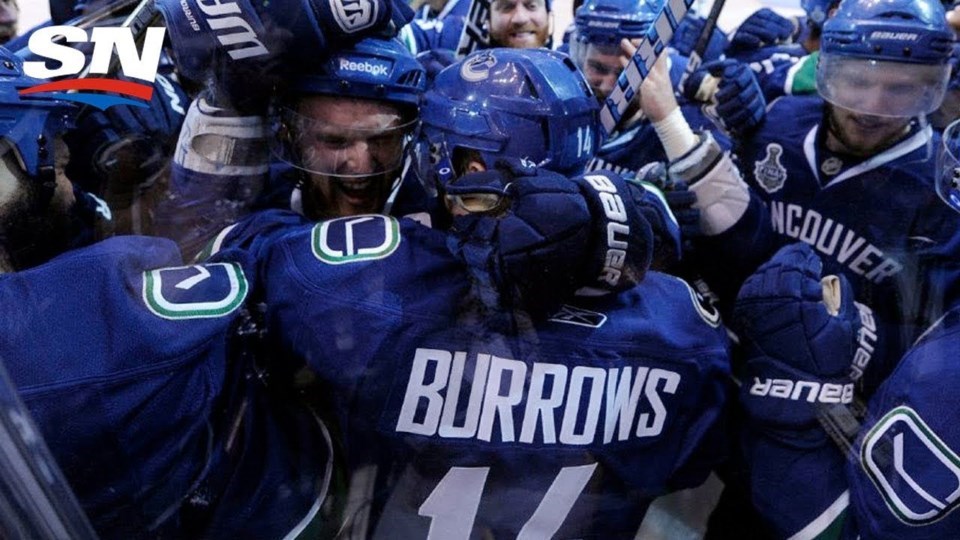 Alex Burrows celebrates his overtime game-winning goal over the Chicago Blackhawks with his Vancouve