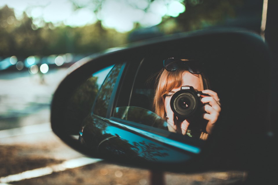 tourist in car taking photo