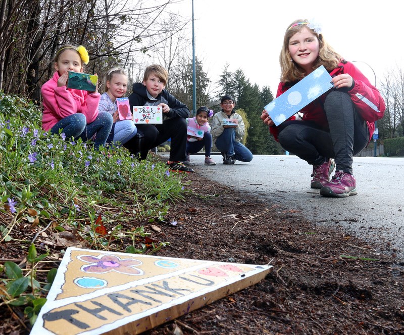 kids and thank you signs