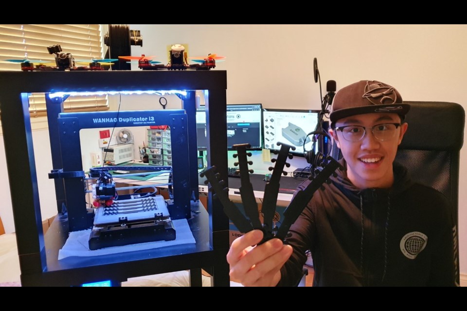 Burnaby North Secondary School Grade 11 student Aaron Lu shows off some of the "ear savers" he has produced on his 3D printer to help medical masks fit more comfortably for health-care staff working long hours during the COVID-19 pandemic.