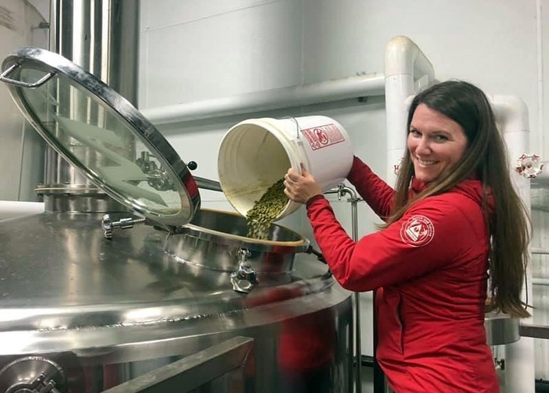 Coquitlam SAR vice-president Helena Michelis throws in some hops to make a special beer that will help raise funds for a rescue boat. Mariner Brewing in Coquitlam is collaborating with Coquitlam SAR on the beer, which will be sold with partial proceeds going to the group.