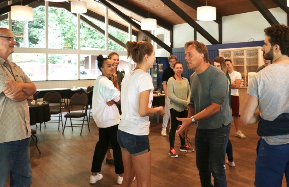 A circle of people standing in the Bowen Lodge