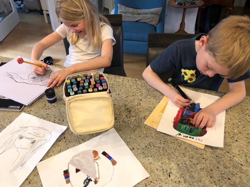 Emily Payne and her brother, Erik, put their creative talents to work in "art class" at home, while mother, Sarah, supervises while also working at her job.