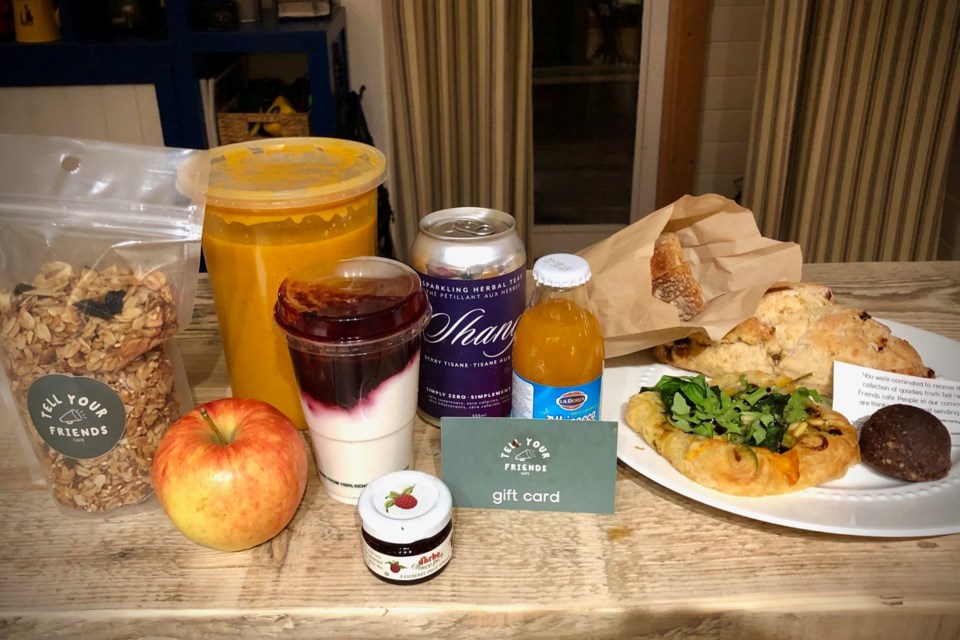 Granola, apple, yoghurt, soup, drinks and pastries on a table.