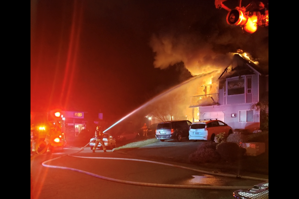 Port Coquitlam firefighters battle a blaze on Mansfield Crescent near Victoria Drive April 11. The family escaped escaped just in time as the home burned with all their possessions inside.