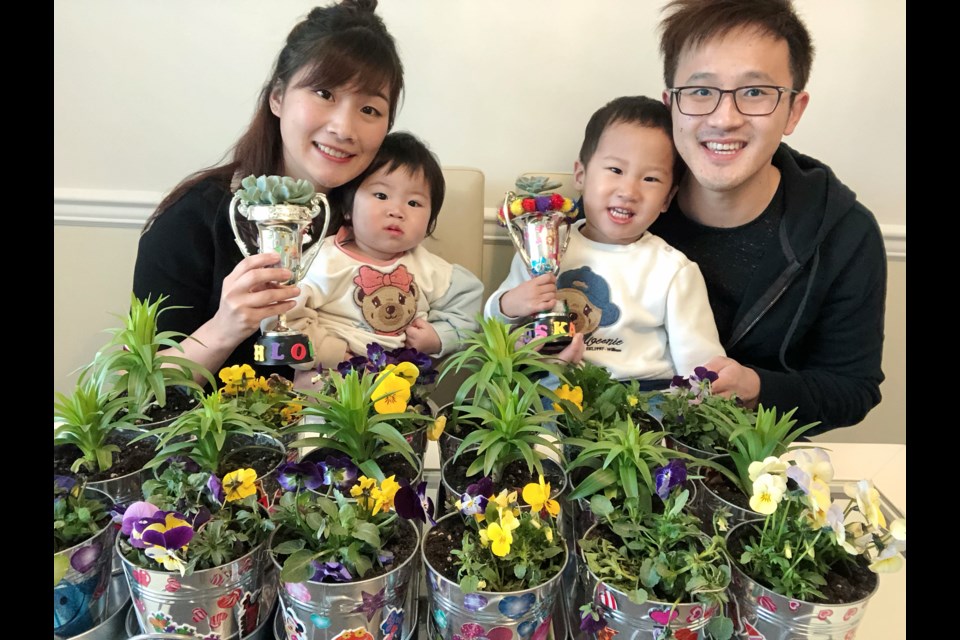 Gary and Daisy Wang, along with their two little kids, are giving out home-made potted plants to all who donate to the hospital. Photo submitted