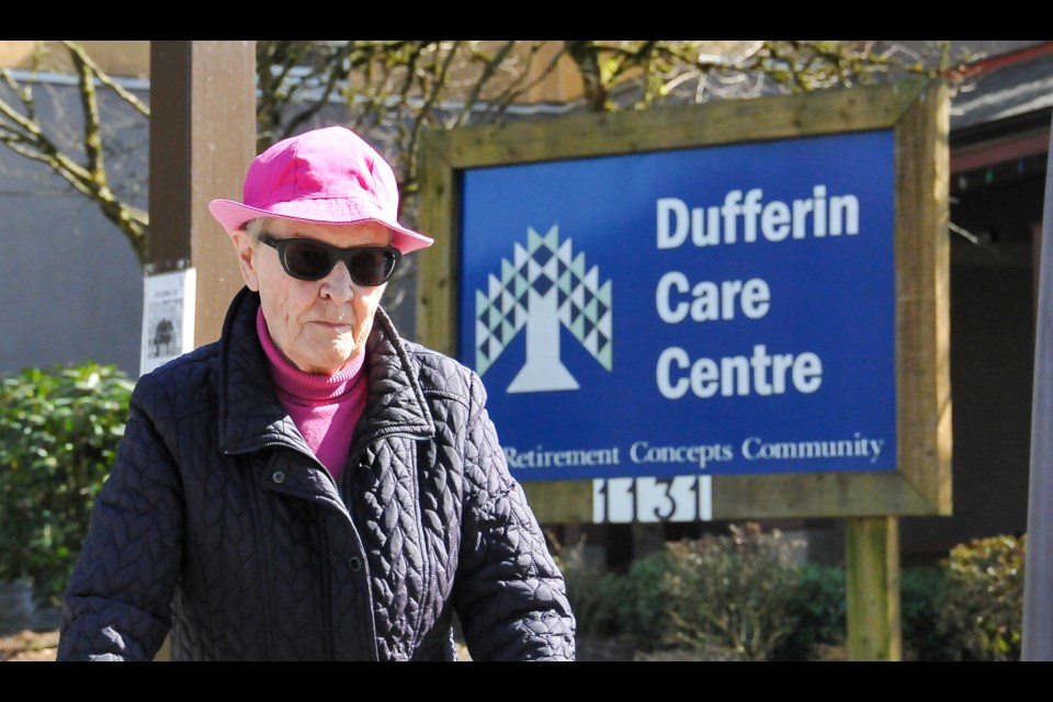 A resident of a nearby seniors home passes in front of the Dufferin Care Centre the day the facility announced its first case of COVID-19.