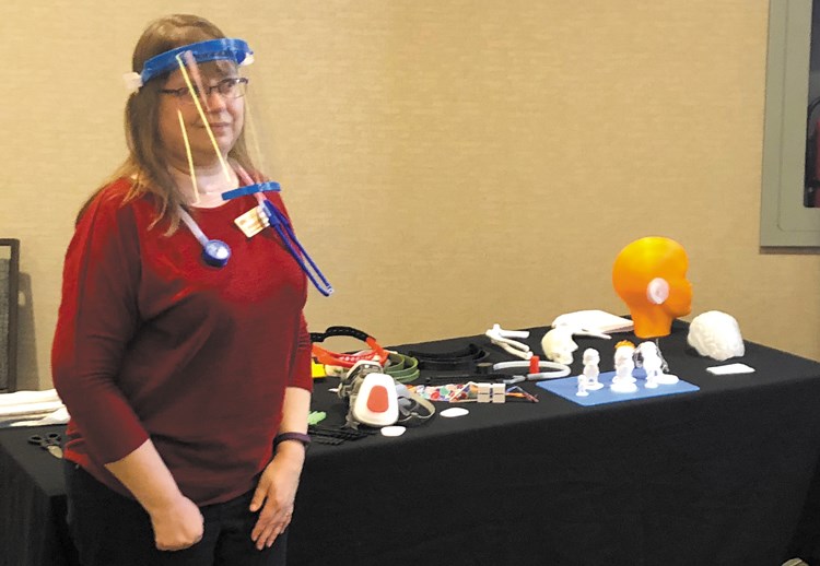 Dr. Malgorzata Kaminska wears a plastic face shield and plastic stethoscope made with 3D printers on Tuesday.