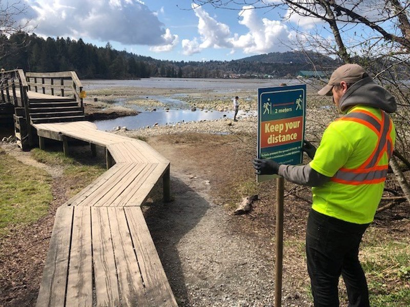 worker installing sign