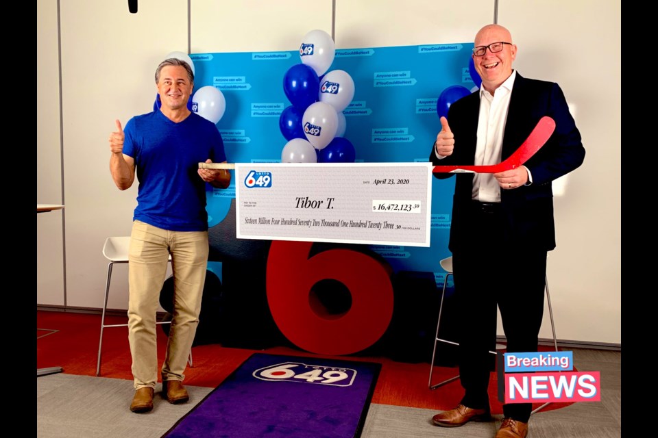 Tibor Tusnady, left, won the $16.4 million Lotto 6/49 Jackpot after buying a ticket last week. He was presented with the cheque on Thursday by BCLC interim CEO Greg Moore, right.