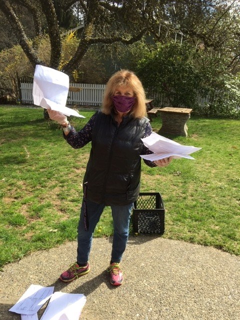 Sue Clarke holding papers in the Little Red Church yard.